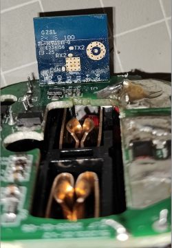 Interior of a Device with CB2S Chip Close-up of the interior of an electronic device with an exposed blue CB2S chip module.