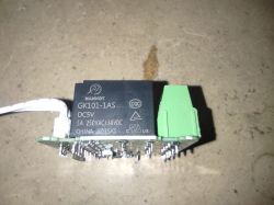 MANHOT GK101-1AS Relay Module Electronic relay module against a concrete surface.