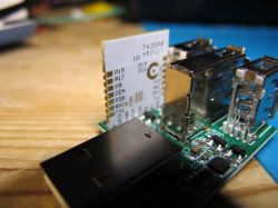 Electronic module with USB components on a wooden table.
