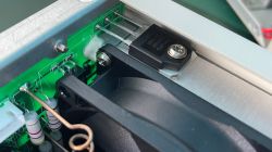View of the interior of a Korad power supply with electronic components, including a transistor and resistors, on a green circuit board.
