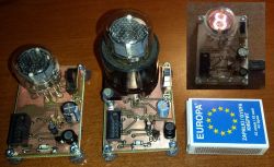 Nixie Tube Testers with Matchbox for Scale Two Nixie tube testers with mounted tubes and a matchbox for size comparison.