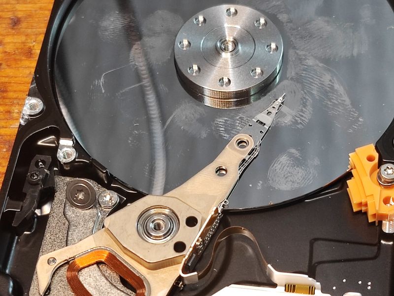 Interior of Hard Drive with Visible Head Image of a hard drive interior with visible platter and head.