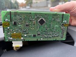 A circuit board with yellow-highlighted soldering areas.