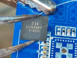 T34 Chip on PCB Close-up of T34 chip on a blue PCB.