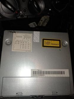 Rear view of a VW RCD300 car radio with informational stickers and barcode.
