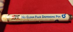 CircuitWorks flux dispensing pen on a red background.