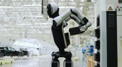 Humanoidalny robot Walker S2 wymienia baterię przy stacji ładowania w hali przemysłowej