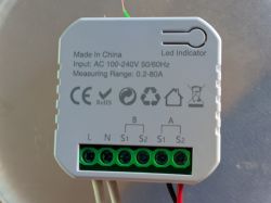 Electrical power meter with visible connectors and labels.