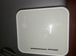 Top view of a TP-Link router model TL-MR3020.