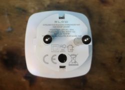 WiFi Smart Socket with Technical Markings Front view of a WiFi smart socket with visible prongs and technical markings.