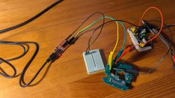 Electronic prototype with breadboard, USB converter, and jumper wires