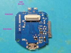 Unlabeled blue PCB with I/O line markings and surface-mounted electronic components