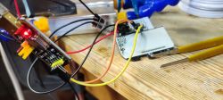 Close-up of Electronic Circuit with Wires on Workbench Close-up of an electronic circuit with wires connected to a PCB, on a wooden work surface.