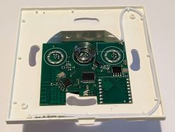 Ener-J Touch Switch PCB PCB with electronic components on a white case of the Ener-J Touch switch.
