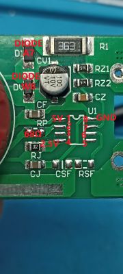 Close-up of PCB with labeled IC pins, voltages, and surface-mounted components