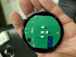 Printed Circuit Board with Electronic Components Person holding a round printed circuit board with electronic components.