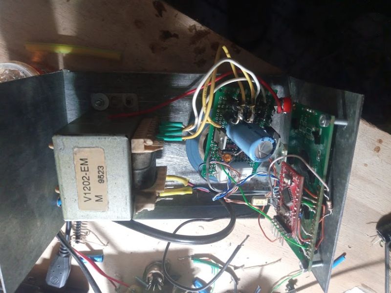 Inside of an electronic device with transformer and circuit boards.