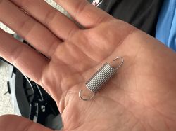 Small extension spring held in an open hand