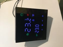Modern touchscreen thermostat displaying 23°C.