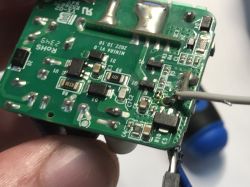 Close-up of Sonoff Mini R4 PCB with a test probe wire connected