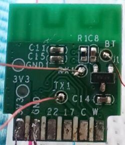 Close-up of a green electronic circuit board with soldered components.