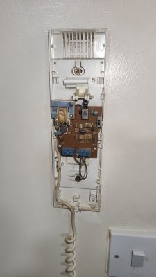 Interior of ACET Intercom Panel Interior of an open intercom panel with visible electronic components and wires.