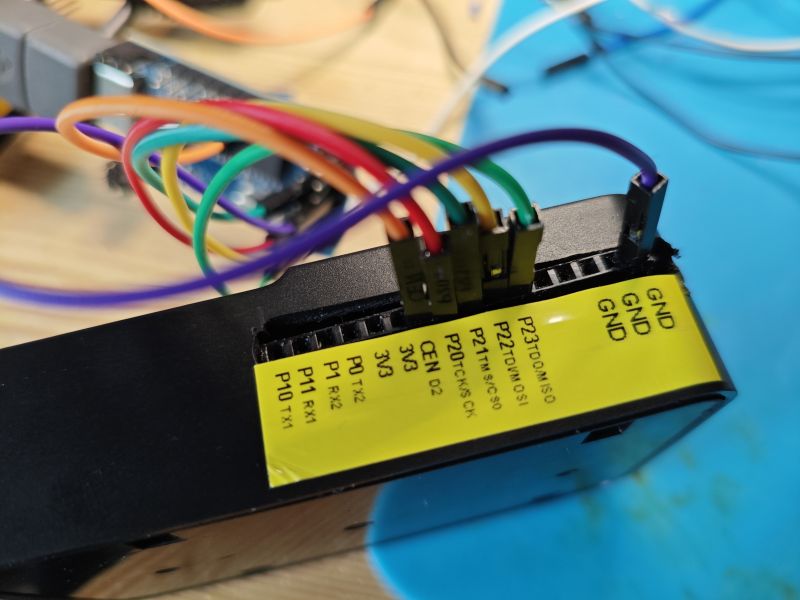 Close-up of connected wires to a GPIO header with yellow label showing pin descriptions