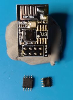 ESP-01S module with a replaced chip, placed next to two smaller chips.