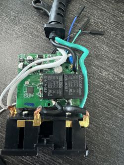 Inside View of Microcenter Smart Plug with PCB Close-up of a Microcenter smart plug with visible PCB and connected wires.