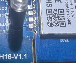 Close-up of a circuit board with marked abrasion next to pin TXD1.