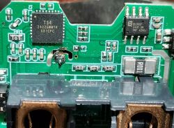Damaged circuit board with electronic components and burn mark.