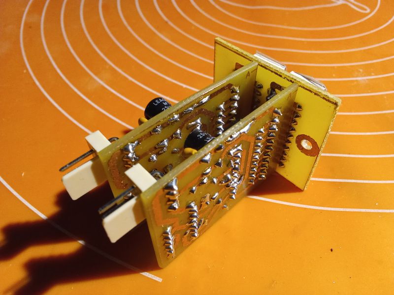 Close-up of a circuit board with electronic components on an orange background.