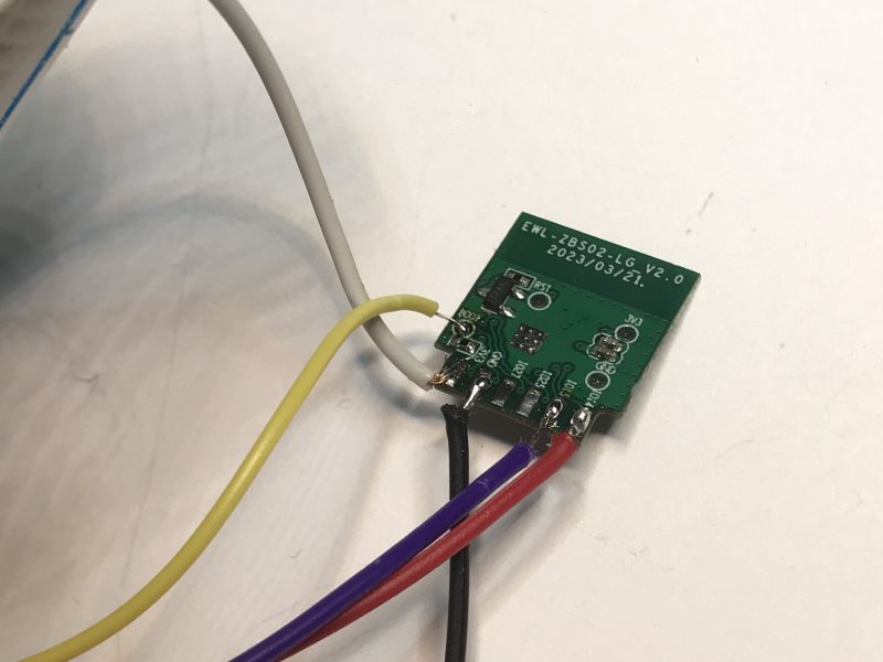 Small green electronic board with connected wires.