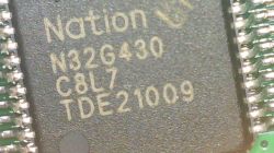 Close-up of N32G430 chip with visible markings and soldered pins on PCB