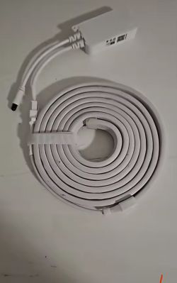 Coiled RGBIC light strip with controller on a white surface.