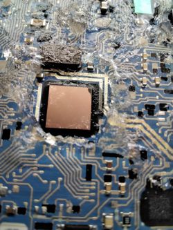 Close-up of a circuit board with visible damage and burn marks.