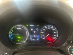 Dashboard of a Mitsubishi Outlander PHEV showing the speedometer and battery charge indicator.
