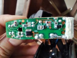 Zbliżenie na zieloną płytkę PCB z elementami SMD, trzymaną w dłoni, z widocznymi oznaczeniami D1 i D5