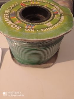 Szpula zielonego kabla Sommercable stoi na płaskiej powierzchni.