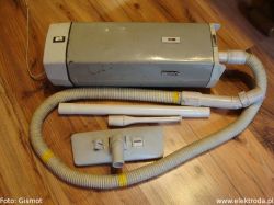 Old Zelmer type 251 vacuum cleaner with hose and nozzle on wooden floor