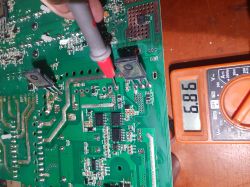 Measuring voltage on a circuit board with a multimeter.