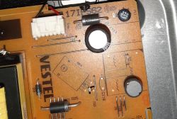 Close-up of a brown VESTEL PCB with a connector, components, and circular mounting holes.