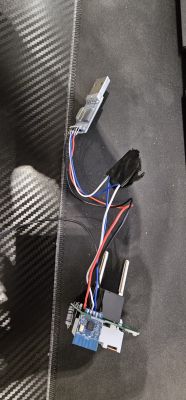 USB plug connected with wires to a circuit board and electronic components.
