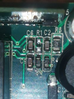 Close-up of a circuit board with a missing capacitor C6.