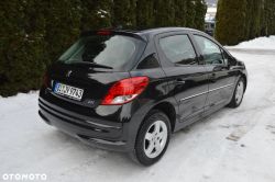 Black Peugeot 207, rear three-quarter view, parked on a snowy surface