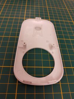 Device Casing on Measurement Grid Mat Plastic device casing on a green grid mat.