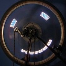 Top view of a rotating arm with LEDs inside a circular housing