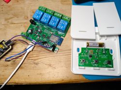 Printed circuit board with electronic components and power supply on a wooden surface.