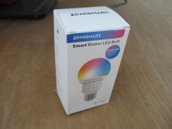 Box of ZMISMART Smart Matter LED Bulb on a wooden table.