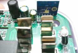 Circuit board with electronic components, including capacitors and an RF module.